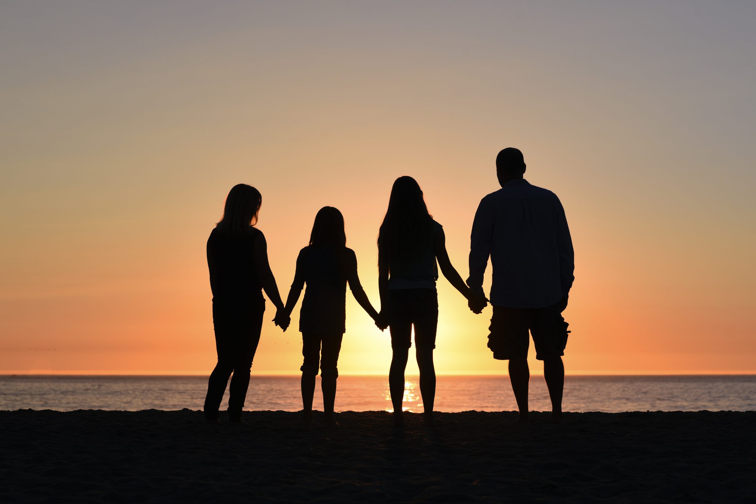 Family of four watching sunset